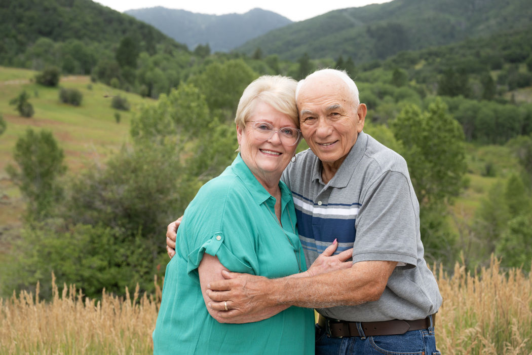 Older couple embracing in the hills during an outdoor couples portrait session in North Ogden, Utah