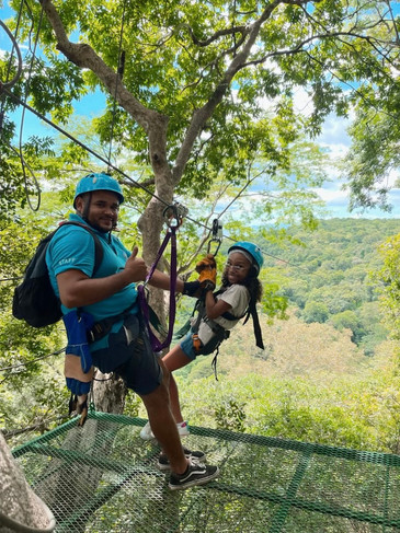 Ziplining platform with guide and child at Witch’s Rock Canopy Tour overlooking forest in Guanacaste, Costa Rica