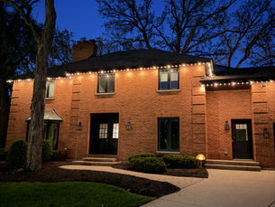 Accu-Bright crew installing permanent RGBW lighting on a Chicago-area home roofline in the western Chicago suburbs