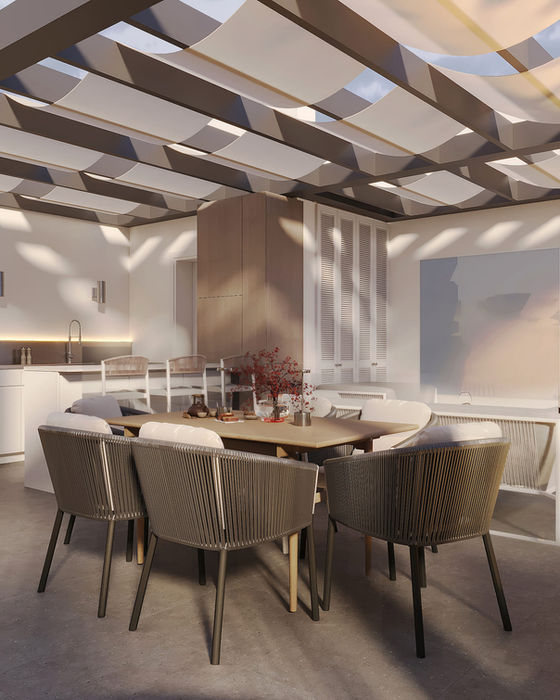 Outdoor dining zone under pergola with rope chairs and large table on rooftop terrace in Limassol