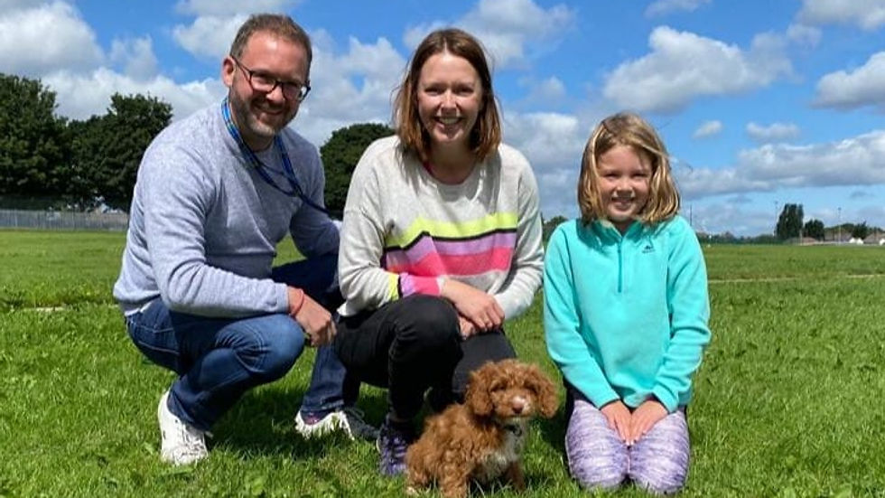 "Happy family welcoming a trained puppy from Puppy Steps"
