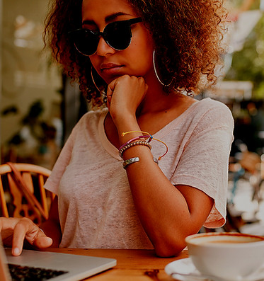 young millennial  women having coffee looking on her lap top