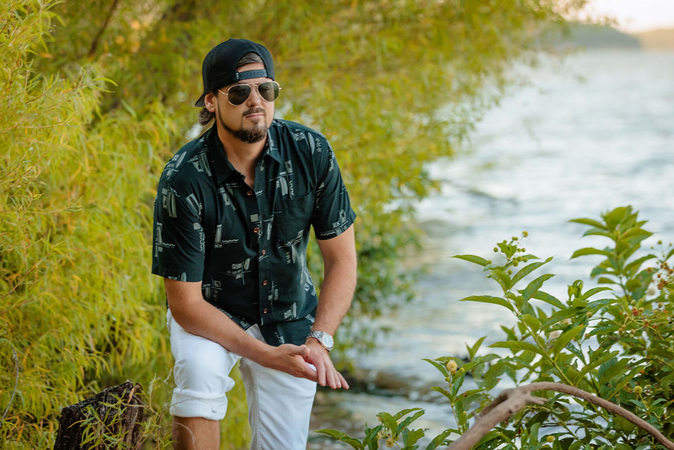 an at the beach leaning on his knee in kc personal branding photoshoot