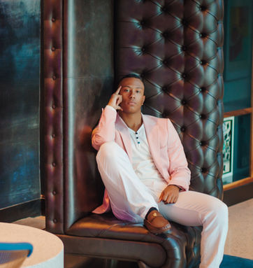MAN SITTING ON AN A COUCH THAT IS ON IT'S SIDE PORTRAIT