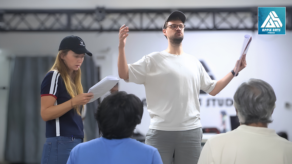 Director briefing actors with script pages during rehearsal — Apple Arts Studios