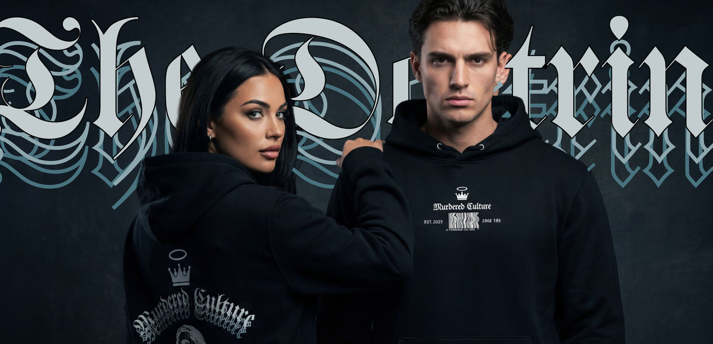 A man and a woman model the Murdered Culture hoodies of The Doctrine with text showing behind them "The Doctrine"