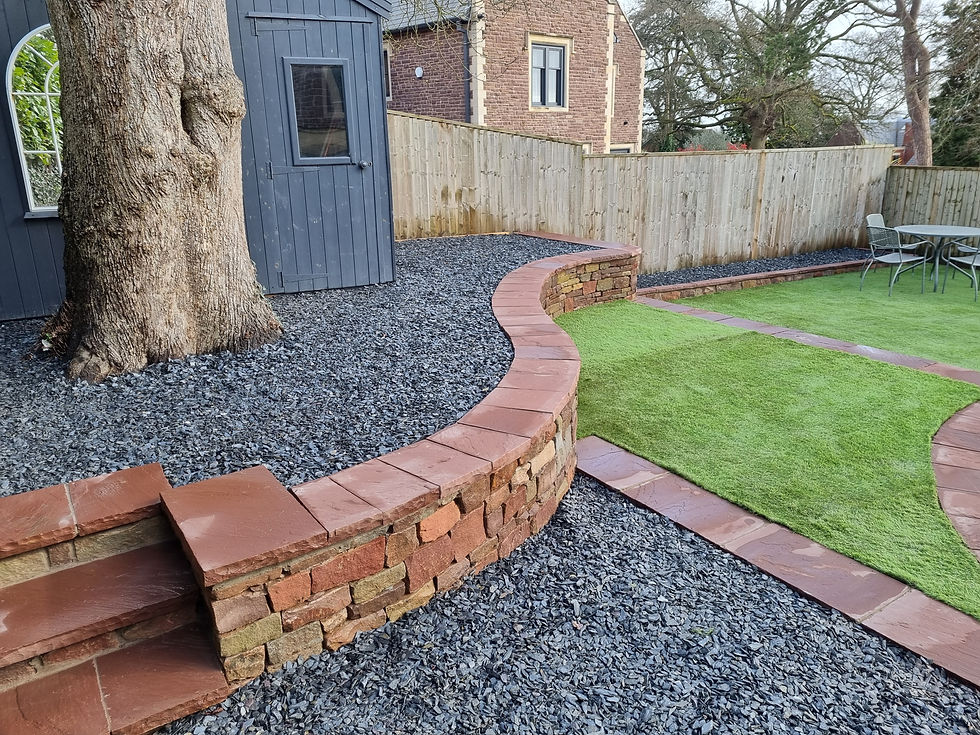 astro turf on three tiers, drystone retaining wall, sandstone coping stones