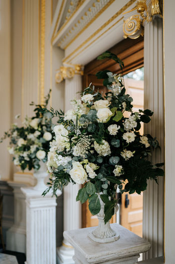 Two urns full of white flowers for a wedding ceremony at Orleans House Gallery, Richmond.  By Myrtle & Smith Flowers.