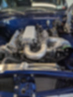 Custom LS engine swap with high-performance intake and turbo components installed in a classic car