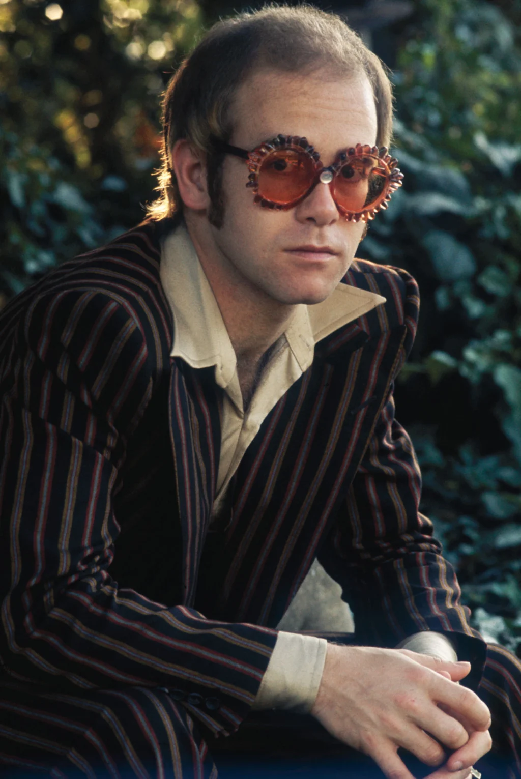Elton John wearing round sunglasses