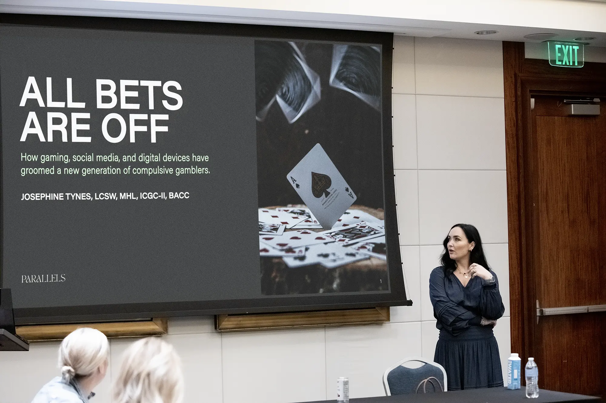 josephine Tynes presenting in front of a screen with the words "All Bets Are Off"