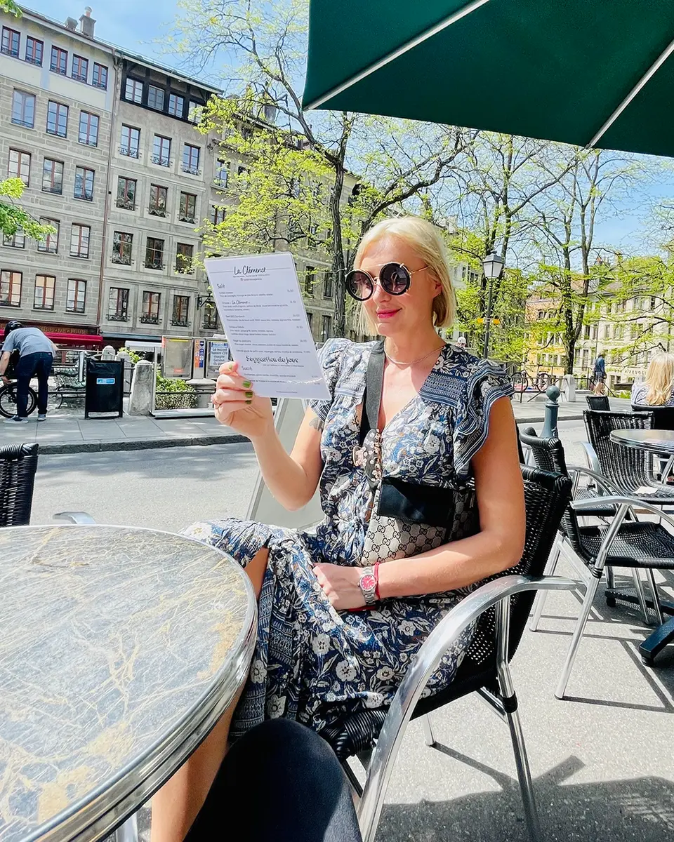 Woman reading menu at an outdoor cafe