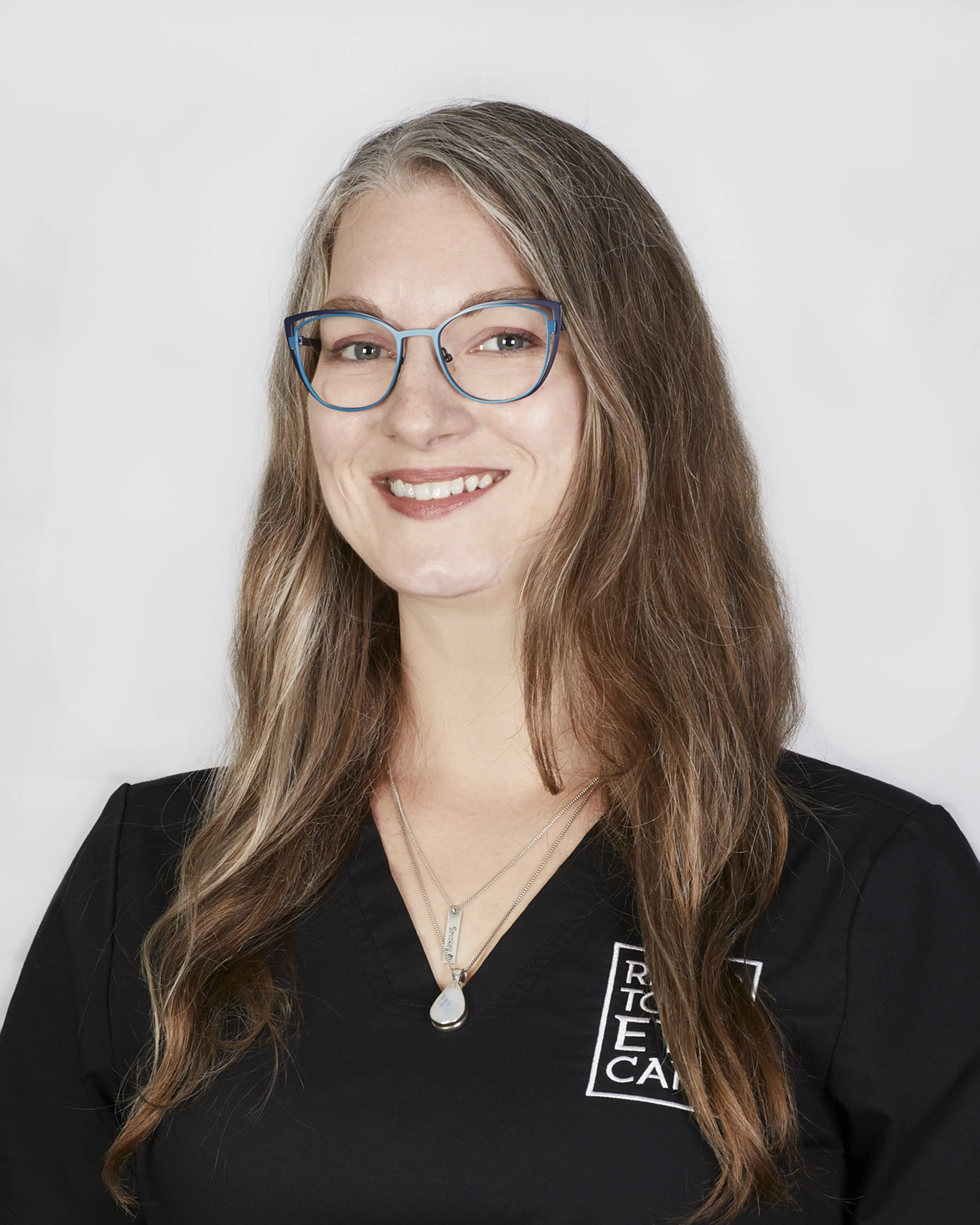 Portrait of smiling woman with long hair and glasses