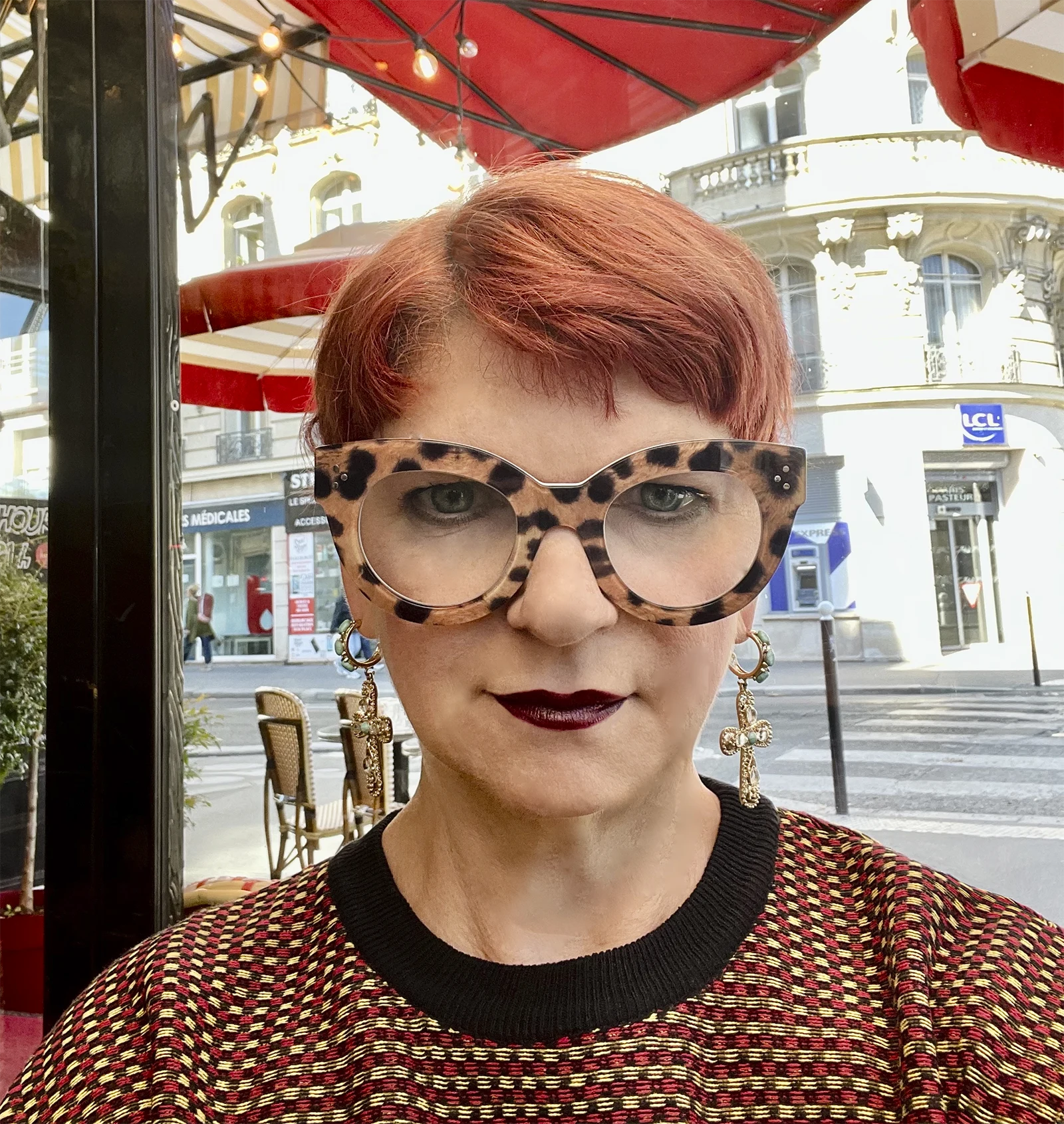Portrait of Colleen Kelly MFT PHD wearing oversized glasses