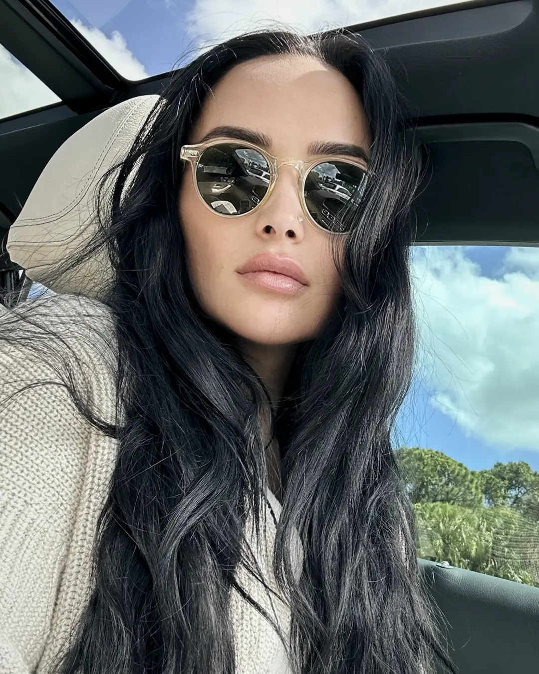 Stylish woman in a luxury car with sunglasses