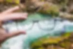 Glasses and a blurry creek