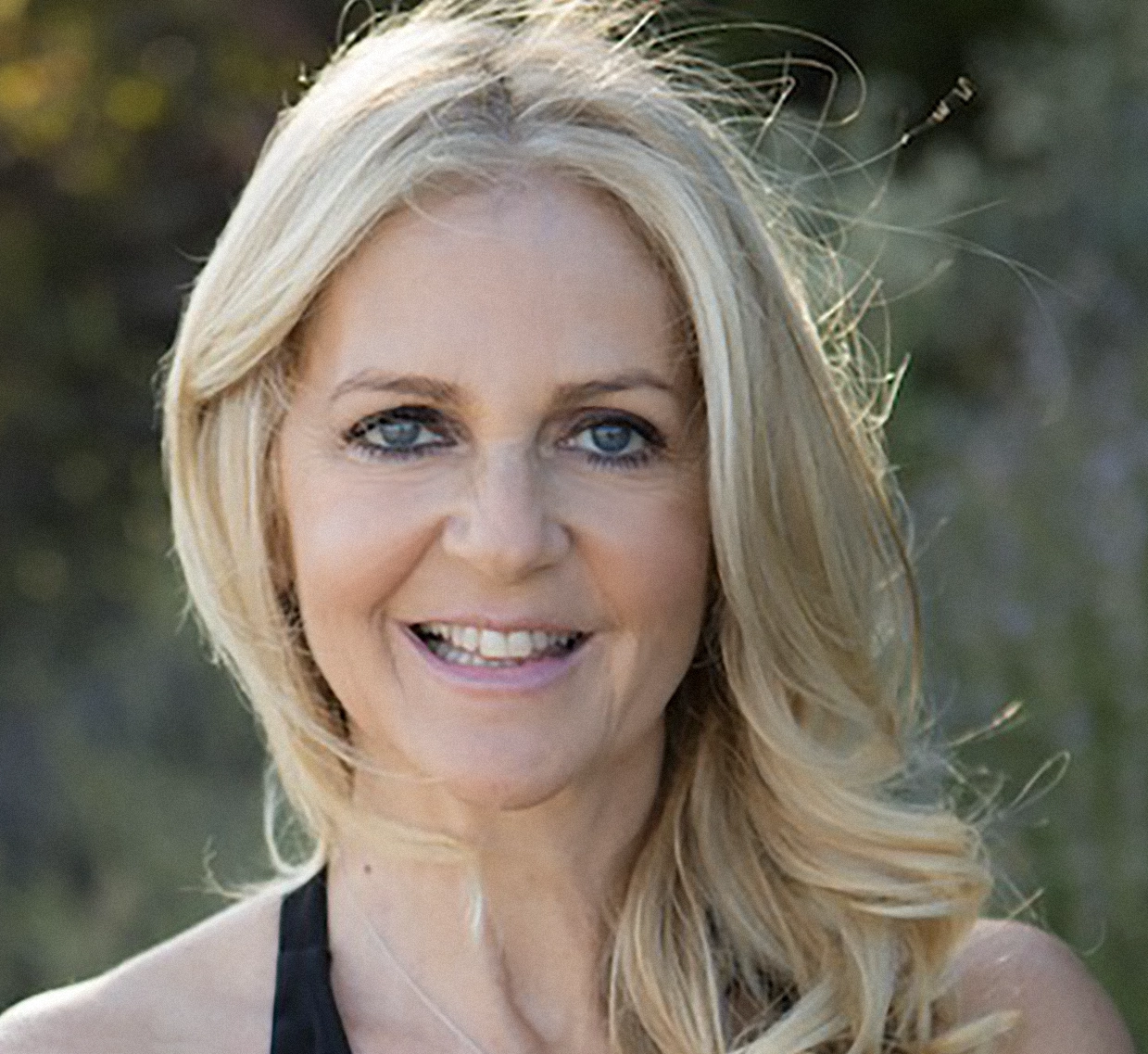 Smiling blonde woman in sunshine