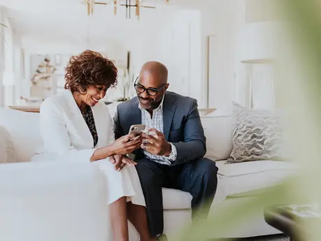 A man and woman looking at a smart phone in Edina