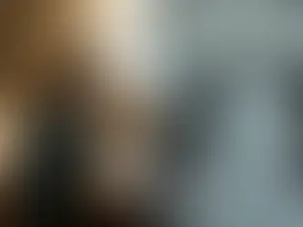 Woman in denim jacket on phone in kitchen; right: crowded call center with rows of people at cubicles, focused atmosphere, muted colors.