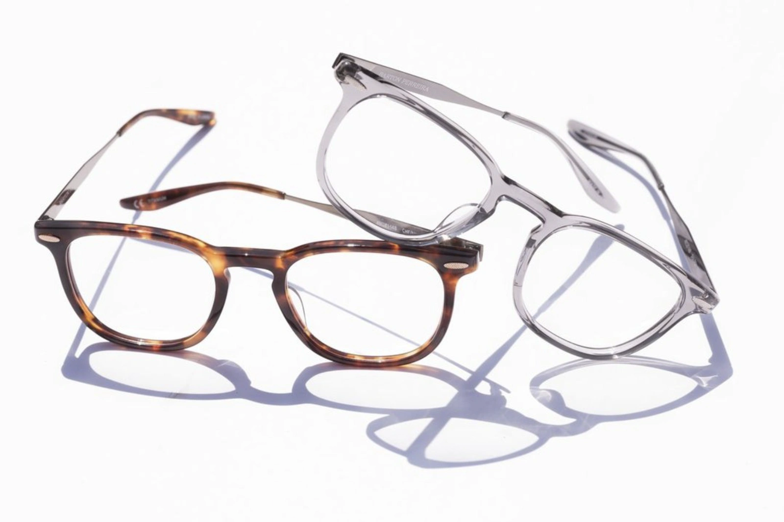 two pairs of designer eye glasses
