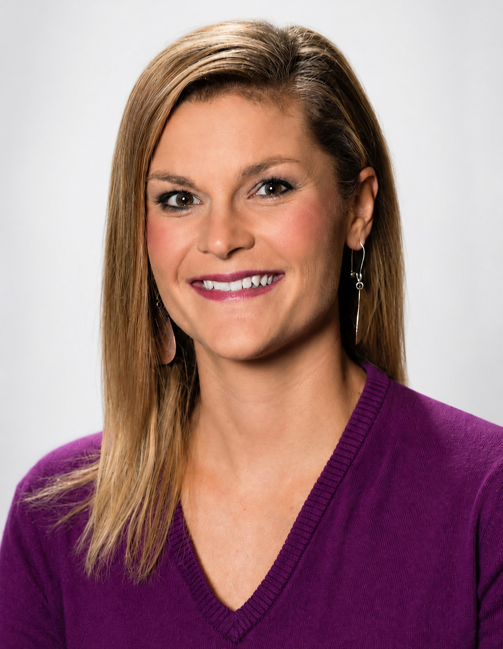 Professional headshot of a woman in a purple top on a light background, portrait, centered face, natural expression, portrait aspect ratio