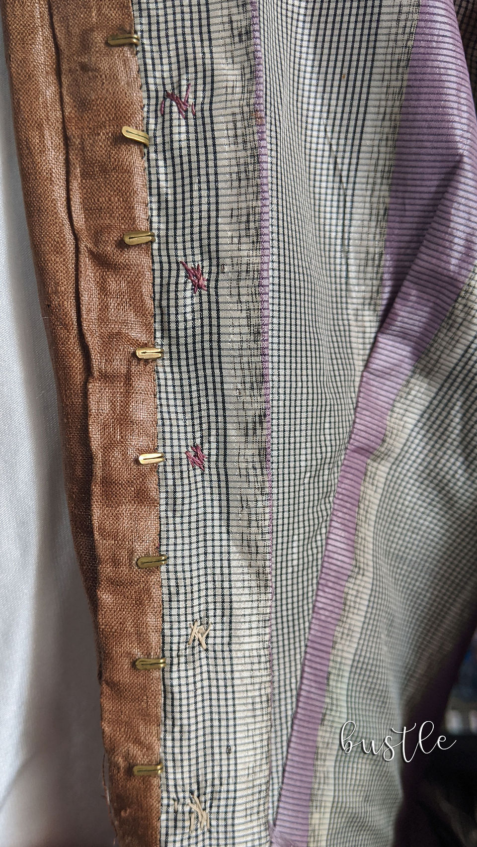 Hook & Eye, along with the different colored threads attaching the silk covered buttons