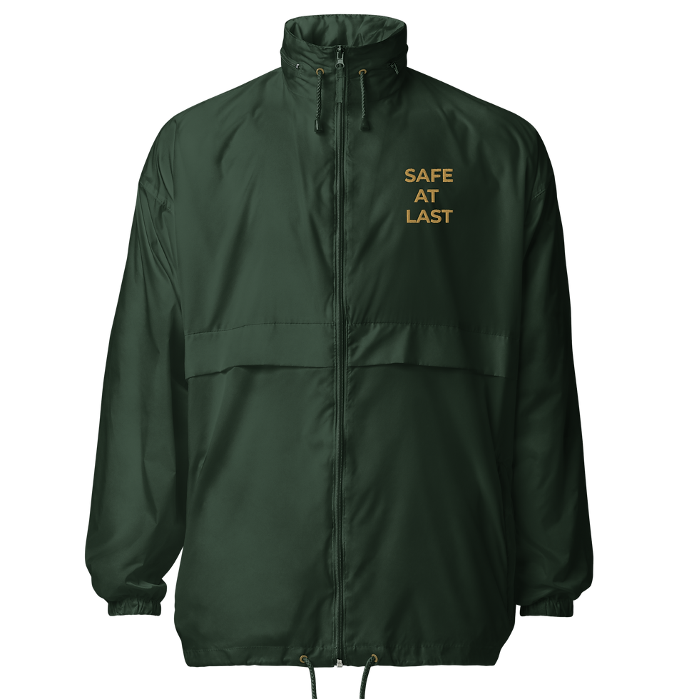 Forest green windbreaker embroidered with the statement SAFE AT LAST.