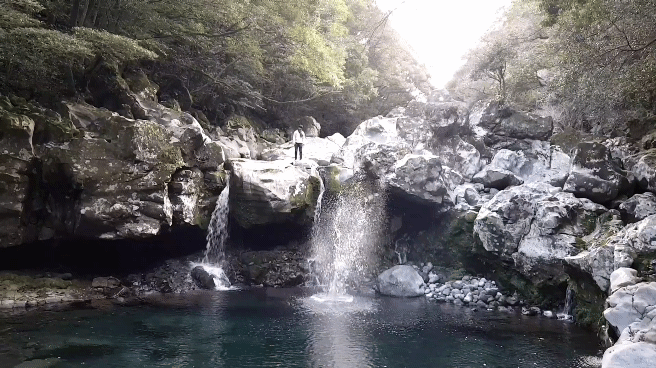 Throwing rock waterfall GIF 