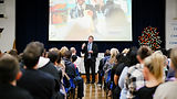 School Event with crowd and headteacher talking