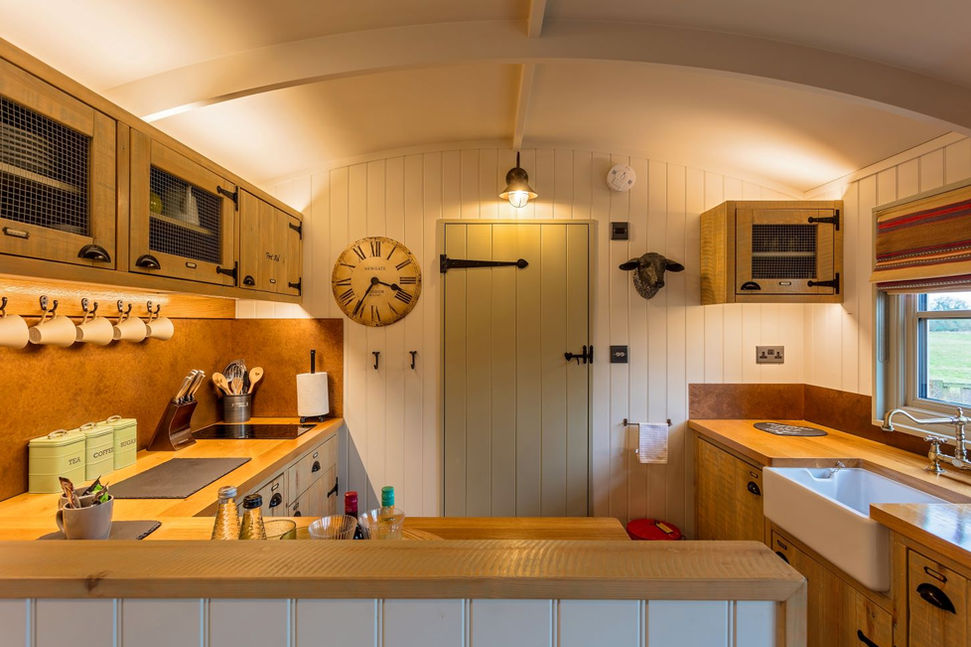 kitchen and door within shepherds hut accommodation