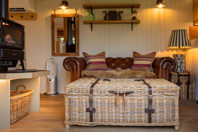 wicker basket inside living room of shepherds hut accommodation