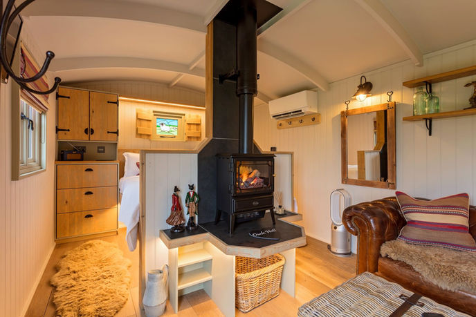 fireplace within living room of shepherds hut accommodation