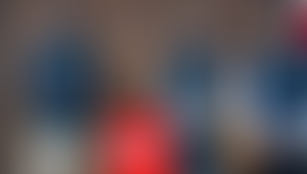 Tom Ralph, Gavin Seymour, and Jonathan Gracie in Onions uniform standing in front of the Norwich Petanque sign.