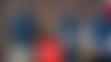 Tom Ralph, Gavin Seymour, and Jonathan Gracie in Onions uniform standing in front of the Norwich Petanque sign.