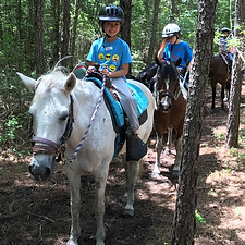 Coast Kids camper riding a horse at summer camp