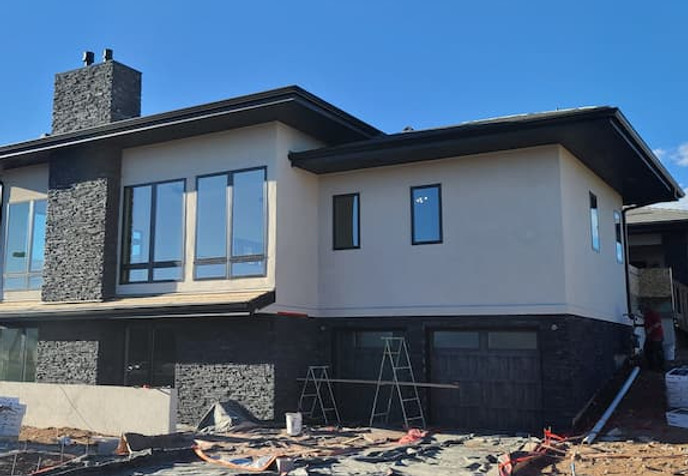 Modern home exterior with stucco and stone installation | L&S Stucco Stone Tile