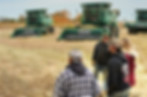 Group of people standing outside on farm field