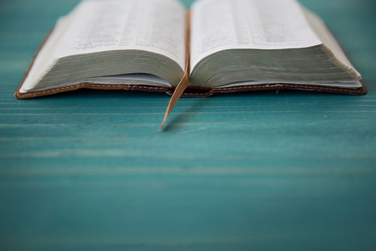 an_open_bible_on_a_green_table-1920x1280.jpg