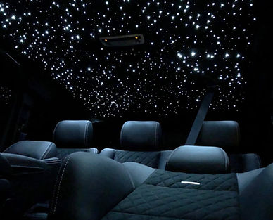 Custom starlight headliner with twinkle effect installed in luxury car interior