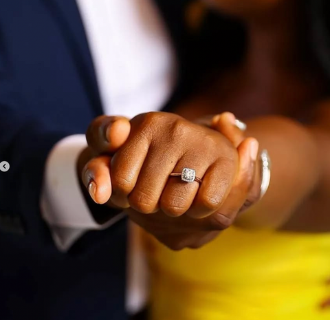 Couple's hands clasped, engagement ring visible, holding hands, love, Jewels by the Sea.