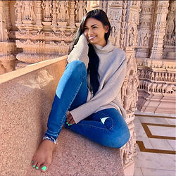 Smiling woman sits at ancient temple