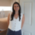 Smiling woman in white vest, acupuncture clinic