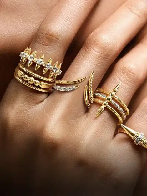 Hand with rings. Jewels by the Sea, gold rings with diamonds, elegant jewelry.