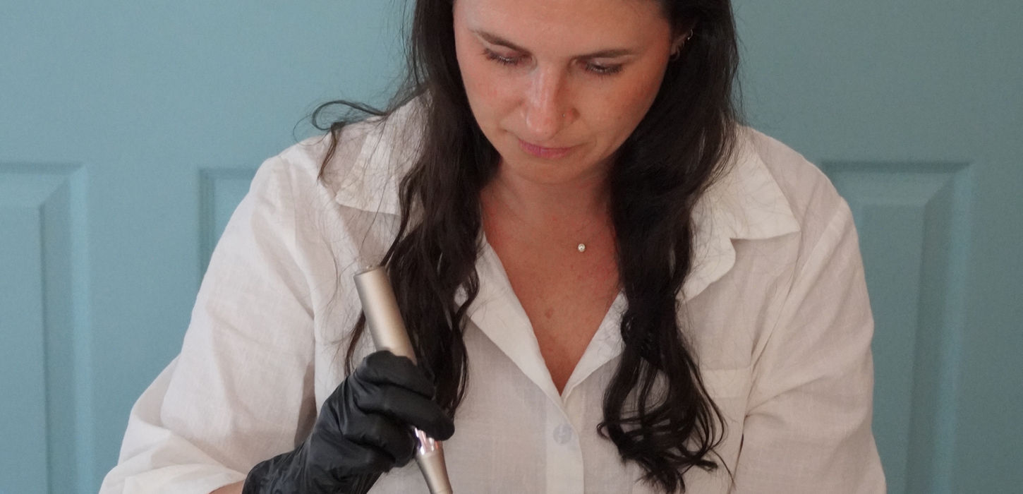 Aesthetician performing facial acupuncture treatment