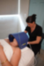 Woman receiving LED light therapy facial treatment