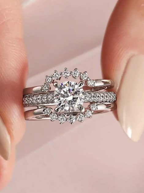 Woman's hands holding diamond rings, sparkling, and elegant. Jewels by the Sea