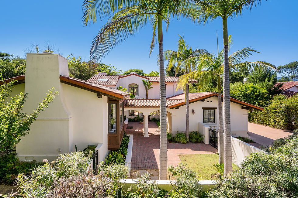 Spanish-style house with terracotta roof and palm trees