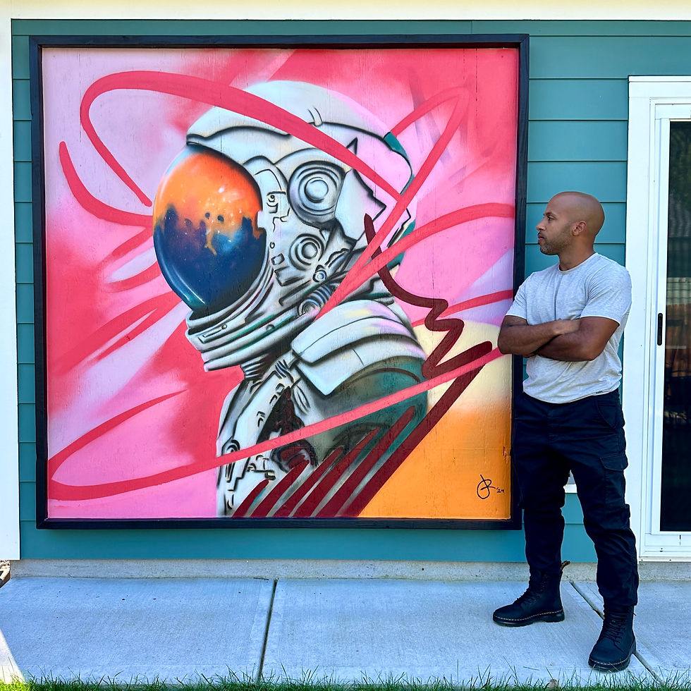 Man stands by astronaut artwork. Juniro Design. Colorful background and design.