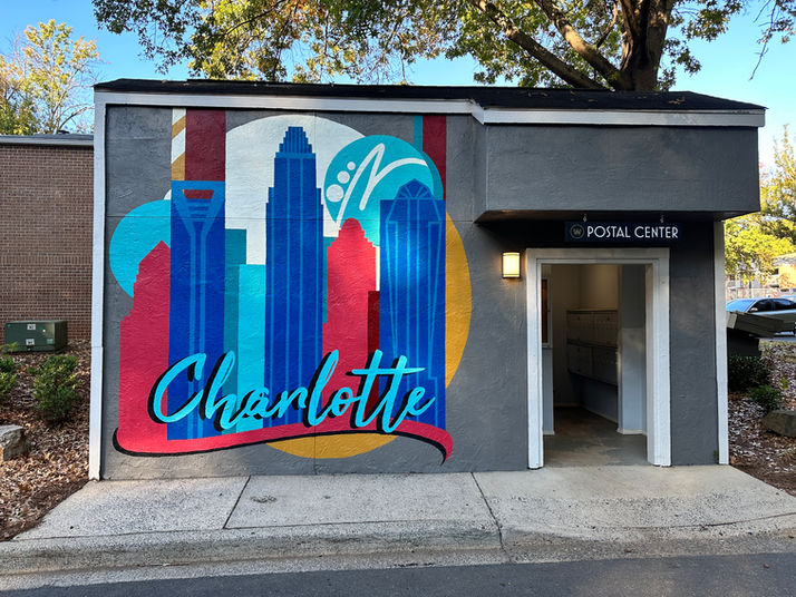 Charlotte skyline mural with text “Charlotte” and “Postal Center” building exterior