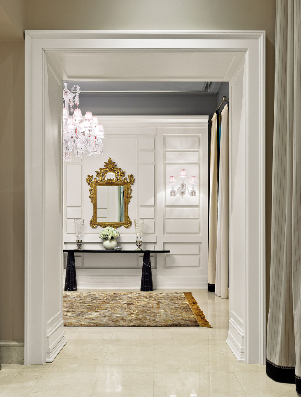 Black door with two gold floor lamps